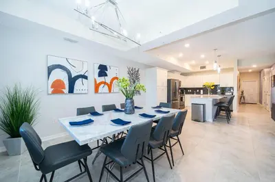 a dining room and kitchen with a table and chairs at 3180-103EF STOREY LAKE, CONDO 2/2 GARDEN VIEW in Kissimmee