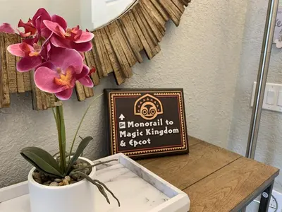a sign on a counter with flowers in a vase at Ohana House at Windsor Hills, Disney World Luxury Rental in Orlando