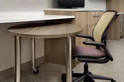 an office desk with a chair and a table at Home2 Suites by Hilton Orlando Downtown, FL in Orlando