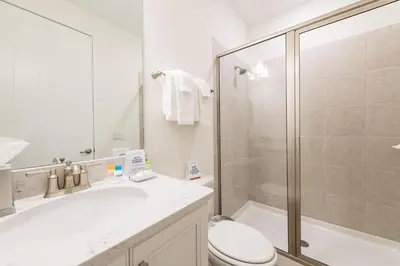 a bathroom with a shower and a toilet and a sink at Vibrant Cottage Near Disney With Margaritaville Resort & Island H20 Waterpark Access- 3000Sp in Orlando