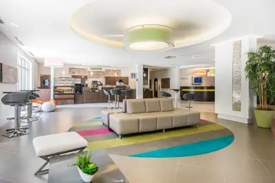 a living room with a couch and a colorful rug at Avanti International Resort in Orlando