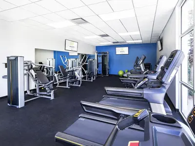 a gym with several treadmills and cardio machines at Avanti International Resort in Orlando