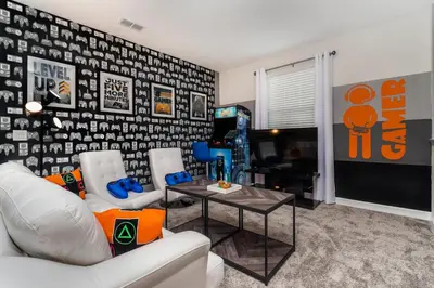 a living room with a white couch and a table at Villa wPrivate Pool &Themed Rooms, near Disney in Kissimmee