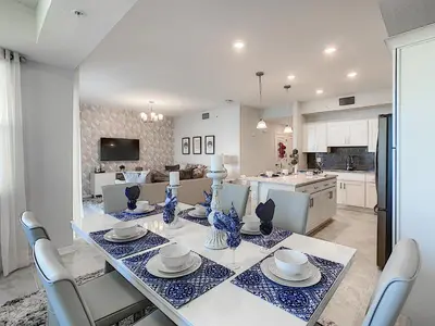 a kitchen and dining room with a table and chairs at 3150 Paradox Circle 107 in Kissimmee