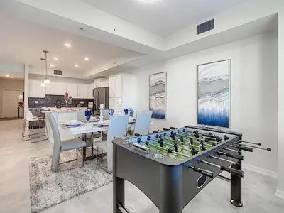 a living room with a foosball game on a table at 3150 Paradox Circle 107 in Kissimmee