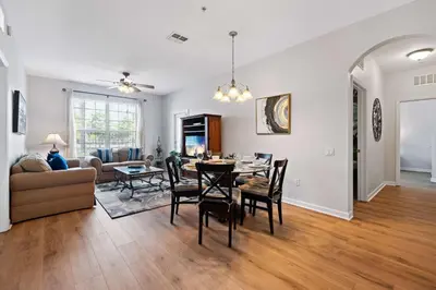 a dining room and living room with a table and chairs at Renovated Condo by Convention Center & I-Drive in Orlando