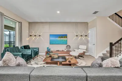 a living room with a couch and a table at VILLA wPrivate Pool & Game Room near Disney in Kissimmee