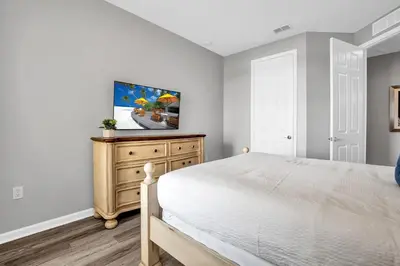 a bedroom with a bed and a tv on a dresser at 4816 Cayview Ave #306 in Orlando