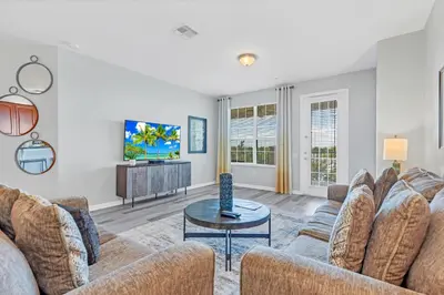 a living room with two couches and a tv at 4816 Cayview Ave #306 in Orlando