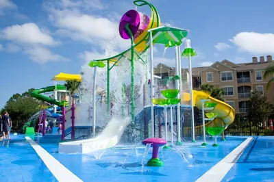 a pool with a water park with a water slide at 7664 Comrow Street #104 in Orlando