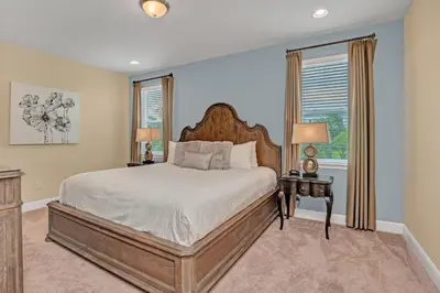 a bedroom with a large bed and a window at Modern Villa wPrivate Pool and Air Hockey Table in Orlando