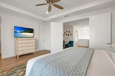 a white bedroom with a bed and a ceiling fan at Large Margaritaville Villa w PRIVATE POOL View in Orlando