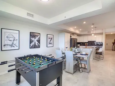 a dining room with a large foosball table at 3131 Paradox Cir Unit 203 in Kissimmee