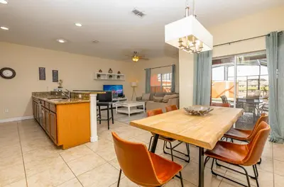 a kitchen and living room with a table and chairs at Spetacular TownHome With Private Pool close to Disney 8919PP in Kissimmee