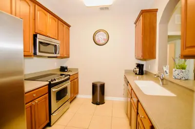 a kitchen with a stove and a sink and a microwave at Vista Cay at Epic Universe - Standard 3 bedroom penthouse in Orlando