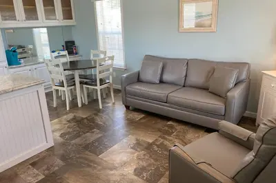 a living room with a couch and a table at Cozy Tiny Home Near Disney World & Orlando Parks! in Kissimmee