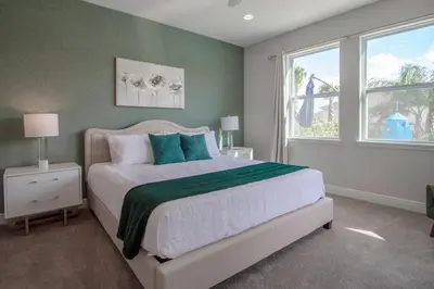 a bedroom with a bed with a green wall at Encore Resort 6 Bedroom Vacation Home with Pool (2102) in Orlando