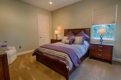 a bedroom with a large bed and a window at Mickeys Atlantis - Luxury 8BR Mansion Oasis Pool Hot Tub Outdoor Kitchen Home Theater, Game Room & More! 2 Miles to Disney in Orlando
