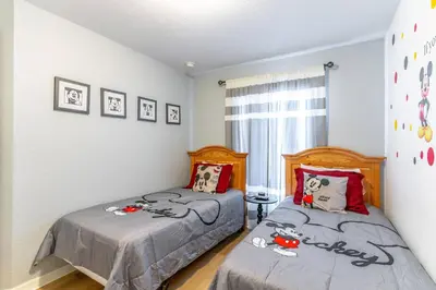 a bedroom with two beds with hello kitty pillows at 17637 Silver Creek in Orlando