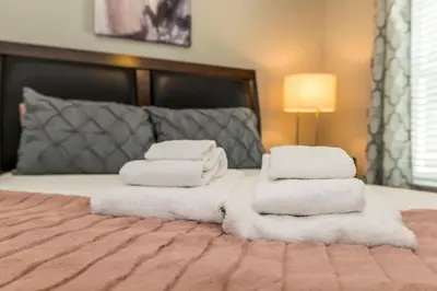 a pile of towels sitting on top of a bed at Roomy Town Home, Mickey-Themed Bedroom! #4BV550 in Kissimmee