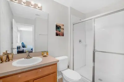 a bathroom with a shower and a toilet and a sink at Roomy Town Home, Mickey-Themed Bedroom! #4BV550 in Kissimmee