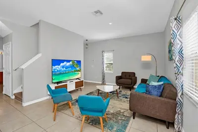 a living room with a couch and a tv at Roomy Town Home, Mickey-Themed Bedroom! #4BV550 in Kissimmee