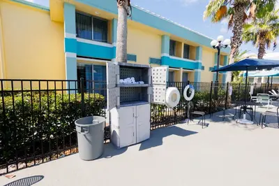 a building with a trash can in front of it at Garnet Inn & Suites, Orlando in Orlando
