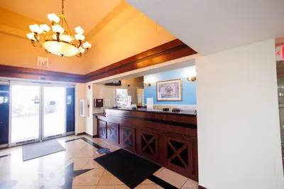 a large kitchen with a counter and a chandelier at Garnet Inn & Suites, Orlando in Orlando