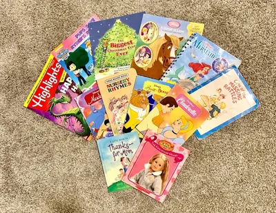 a pile of childrens books sitting on the floor at 3B2B-Beautiful Lake View-Baby Friendly-FREE WATER PARK!NO Resort Fee-5 Miles to Disney-Storey Lake 3141 in Kissimmee
