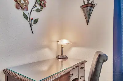 a table with a lamp on top of a wall at Magical Adventure Condo w Waterpark near Disney No Resort Fees in Orlando