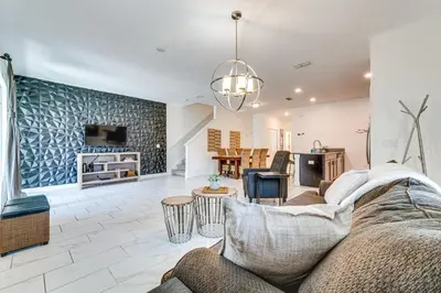 a living room with a couch and a table at 7 Mi Walt Disney World! Family Gem with Private Pool in Kissimmee