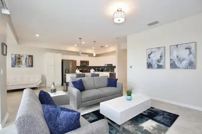 a living room with a couch and a table at Amazing apartment in lux resort Storey Lake with great amenities 10 miles to Disney! in Kissimmee