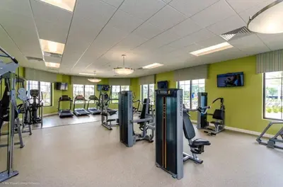 a gym with treadmills and elliptical machines at Amazing apartment in lux resort Storey Lake with great amenities 10 miles to Disney! in Kissimmee