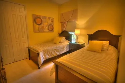 a bedroom with two beds and a white door at Mickeys Getaway - CUSTOM 8BR Luxurious Retreat Pool Hot Tub Theater RM Gym! Outdoor Kitchen 2 Miles to Disney in Orlando