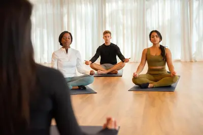 a group of people sitting in a yoga class at Lake Nona Wave Hotel in Orlando