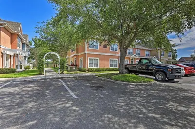 a truck parked in a parking lot in front of a building at 10 Mi to Disney Venetian Bay Villages Retreat in Kissimmee