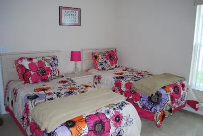 two beds sitting next to each other in a bedroom at Luxury 5-Bed Villa, located only 3 miles from Disney World in Kissimmee