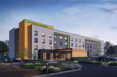 a rendering of a hotel with a parking lot at Wyndham Garden Orlando Airport - Free Airport Shuttle in Orlando