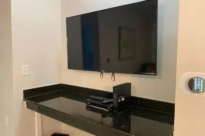 a bathroom with a black counter with a mirror at LUXURY and VINTAGE space to enjoy your vacation!! in Kissimmee