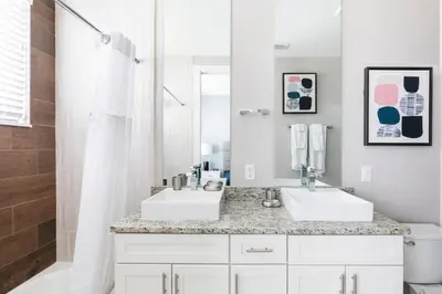 a bathroom with two sinks and a mirror at Summerville Resort 4 Bedrooms Villa in Orlando