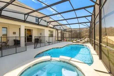 a swimming pool in a house with a glass roof at 5 Bed 5 Bath in 5 Star Resort Near Disney! home in Kissimmee