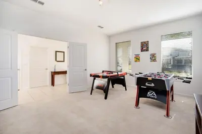 a room with a ping pong table in it at 5 Bed 5 Bath in 5 Star Resort Near Disney! home in Kissimmee