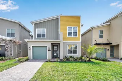 a home with a yellow and gray house at Boutique Style Home Near Disney! home in Kissimmee