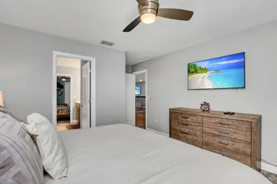 a bedroom with a bed and a ceiling fan at Storey Lake Resort 9 Bed Game Theater Room home in Kissimmee