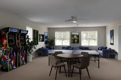 a room with a table and chairs and consoles at Amazing 3 bedroomloft townhouse in Hidden Forest, with private pool! in Orlando