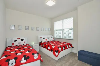 a bedroom with two beds with black and white cows sheets at High luxury 3 bedroomloft townhouse in Hidden Forest, with private pool! in Orlando