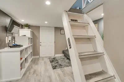 a staircase in a room with white shelves at Family Home with Private Pool 24 Mi to Disney! in Saint Cloud