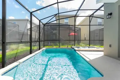 an indoor swimming pool with a glass walled in swimming pool at Gorgeous 5BDR Family with Pool at Storey Lake 2767 O in Kissimmee