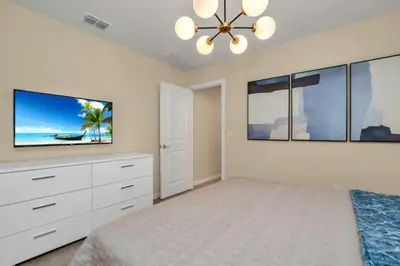 a bedroom with a bed and a flat screen tv at Amazing Game Room Your Kids Will Love! villa in Kissimmee