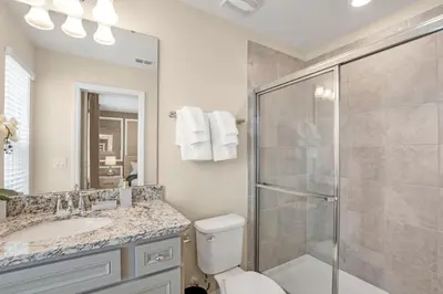 a bathroom with a shower and a toilet and a sink at Amazing Game Room Your Kids Will Love! villa in Kissimmee